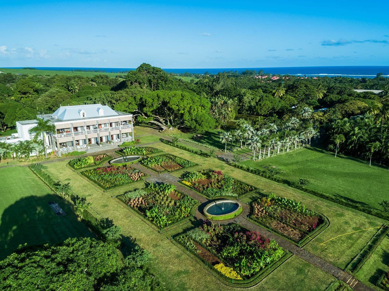 Aerial view of colonial château with formal gardens in Mauritius
